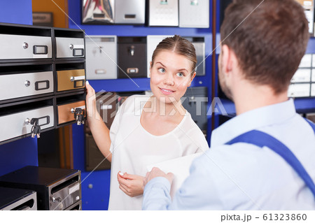 woman with guy seller selecting postbox woman with guy seller selecting postbox 61323860
