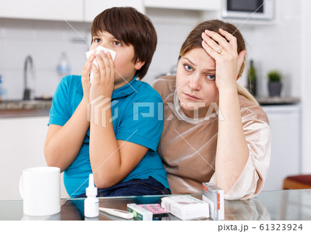Sick boy with mother at home 61323924