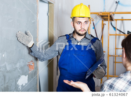 Worker man is clarifying details of work from client. 61324067
