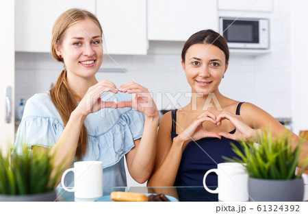 Two smiling girls friends in perfect mood Two smiling girls friends in perfect mood 61324392