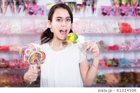 Emotional schoolgirl with lollipop Emotional schoolgirl with lollipop 61324506