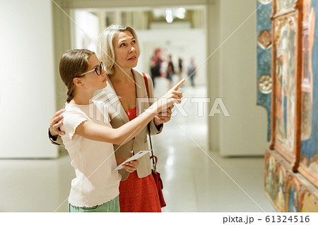 Woman and girl visiting museum Woman and girl visiting museum 61324516