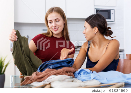 Girls talking and showing each other clothes Girls talking and showing each other clothes 61324669
