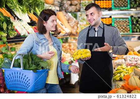 Male seller assisting in buying Male seller assisting in buying 61324822