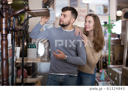 Girl with boyfriend buying hallstand Girl with boyfriend buying hallstand 61324843