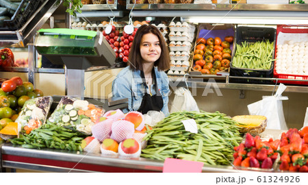 Female seller is showing assortment Female seller is showing assortment 61324926