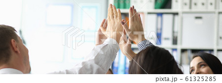 Group business people hive five against office 61325285