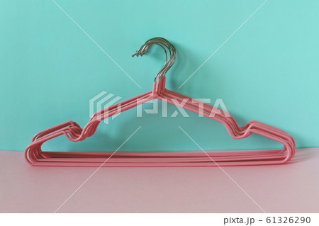 Clothes hangers on blue-pink background Clothes hangers on blue-pink background 61326290