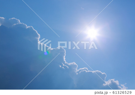 hot summer sun on clear blue sky with cloud 61326529