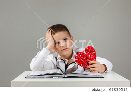 child boy with red heart and book 61330515