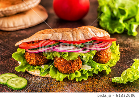 Falafel and fresh vegetables in pita bread. Falafel and fresh vegetables in pita bread. 61332686