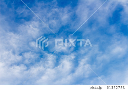 clouds form a mosaic against the blue sky. 61332788