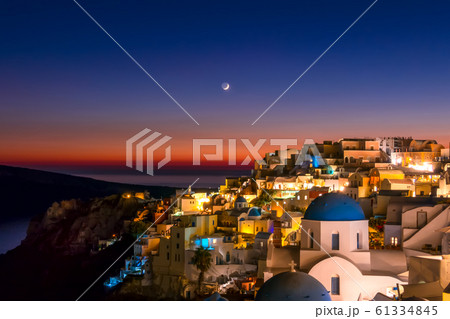 Late Evening and the Moon Over the Rooftops of Oia 61334845