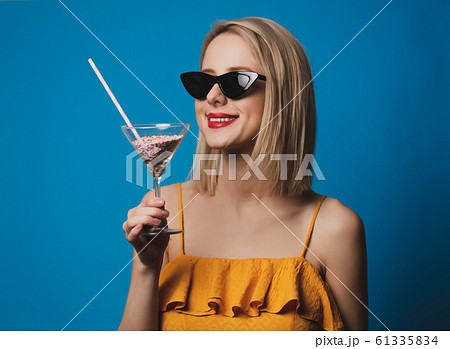 girl with candy cookie on blue background girl with candy cookie on blue background 61335834