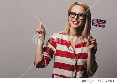 girl holds British flag on gray background 61337463