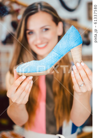 Woman shopping for shoes falls in love with blue high heels Woman shopping for shoes falls in love with blue high heels 61337580