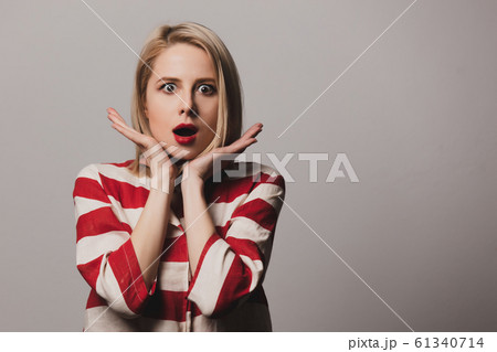 Surprised beautiful londe woman in striped jacket Surprised beautiful londe woman in striped jacket 61340714