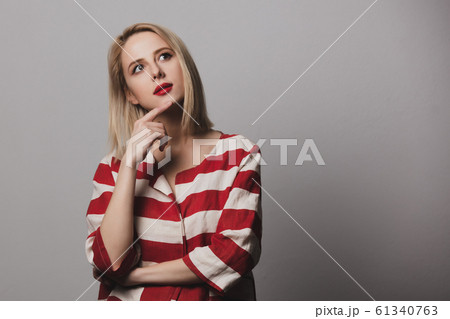 beautiful Surprised blonde woman in striped jacket 61340763