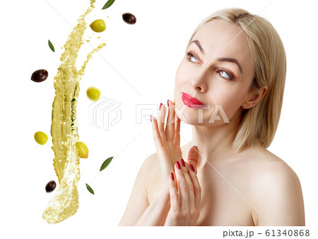 Beautiful woman near splash of olive oil. Skincare adult concept. 61340868