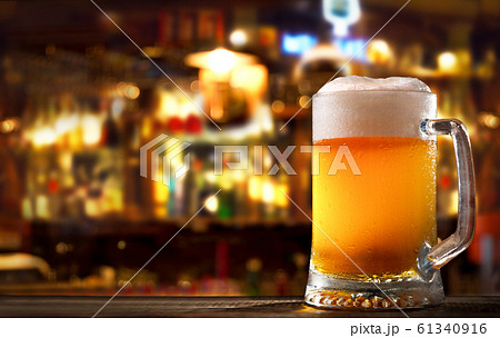 cold mug of beer in a bar on wooden table 61340916