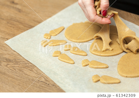 close up of female hands making cookies from fresh 61342309