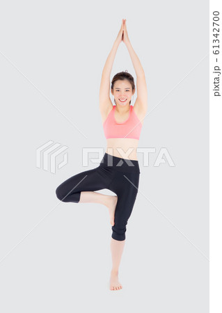 Beautiful happy young asian woman doing yoga exercise sport for leisure and relax isolated 61342700