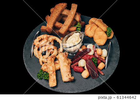set of snacks for beer from crackers, onion rings, sausage and cheese 61344642