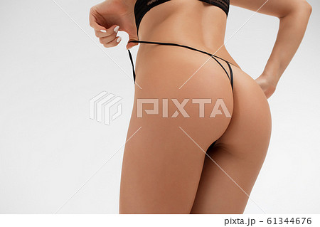 Young lady in lace lingerie leaving buttocks bare 61344676