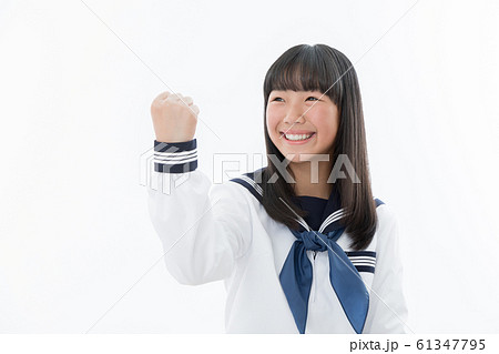 中学生 高校生 女性 セーラー服 ガッツポーズの写真素材