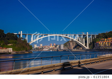 View of the Douro River and the Arrabida Bridge in a beautiful early spring day at Porto City in Portugal 61351864