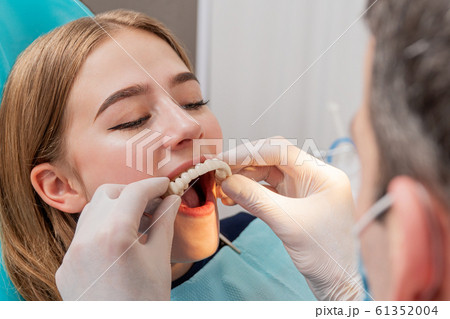 doctor tries on a denture 61352004
