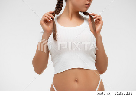 Crop sensual young lady taking off shirt 61352232