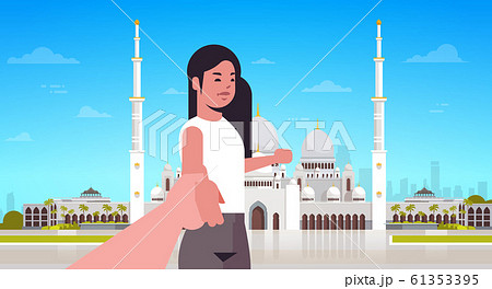 travelers taking follow me photo on background of nabawi mosque building live streaming traveling blogging concept tourists sightseeing muslim cityscape horizontal portrait 61353395
