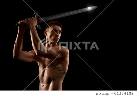Warrior fight with sword isolated on black. 61354108
