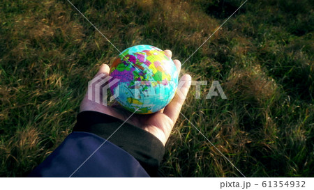 world in hand, female hand holding planet globe 61354932