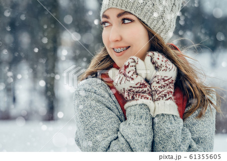 Winter young woman portrait. Beauty Joyful Model Girl laughing and having fun in winter park. Beautiful young female outdoors, Enjoying nature, wintertime 61355605