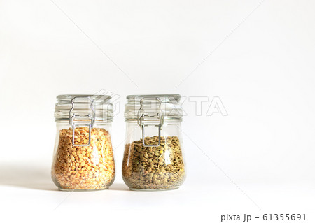 Green lentils and yellow chopped peas are tightly closed in glass containers. Legumes are stored in banks. Healthy food for vegetarianism and other diets. Safe and ecological food storage. Protein Green lentils and yellow chopped peas are tightly closed in glass containers. Legumes are stored in banks. Healthy food for vegetarianism and other diets. Safe and ecological food storage. Protein 61355691