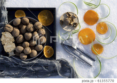 winter flat lay with walnut on black tray, winter flat lay with walnut on black tray, 61355770