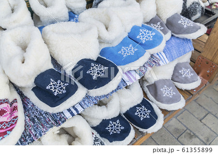 colorful woven home shoes on shelves at market 61355899