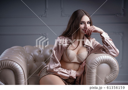Beautiful woman with long hair sensual beige lingerie studio photoshoot 61356159