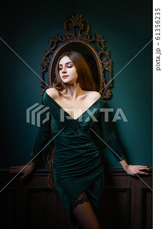 Beautiful woman with long hair sensual greed dress and stockings studio photoshoot Beautiful woman with long hair sensual greed dress and stockings studio photoshoot 61356235