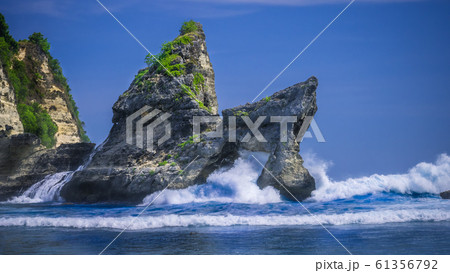 Huge Wave hitting the Rock in the ocean at Atuh beach on Nusa Penida island, Indonesia Huge Wave hitting the Rock in the ocean at Atuh beach on Nusa Penida island, Indonesia 61356792
