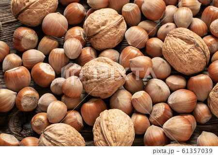 Closeup of whole walnuts and hazelnuts on a table 61357039