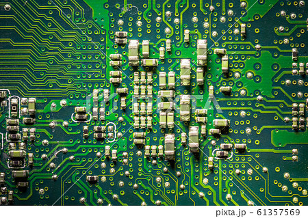Close-up board with micro chips from an electrical appliance or computer. Concept of modern technology. Concept of electronics and microchips. SMD capacitors and resistors on green PCB. Close-up board with micro chips from an electrical appliance or computer. Concept of modern technology. Concept of electronics and microchips. SMD capacitors and resistors on green PCB. 61357569