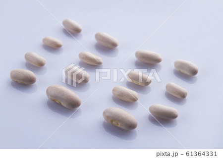 Disposed rows of white beans. Disposed rows of white beans. 61364331