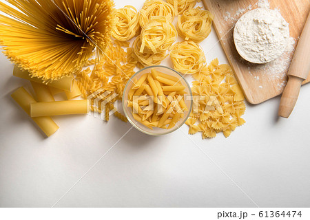 Different kinds of pasta on a white background 61364474