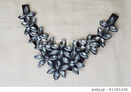 A female triangle-shaped necklace decorated  61365240