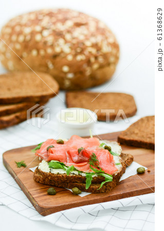 Smoked salmon sandwich with cheese, pistachio and Smoked salmon sandwich with cheese, pistachio and 61368629