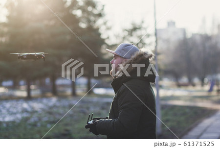 Man operating a drone 61371525