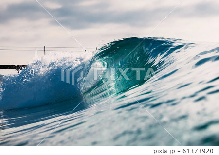 Barrel wave for surfing in ocean. Breaking transparent wave 61373920